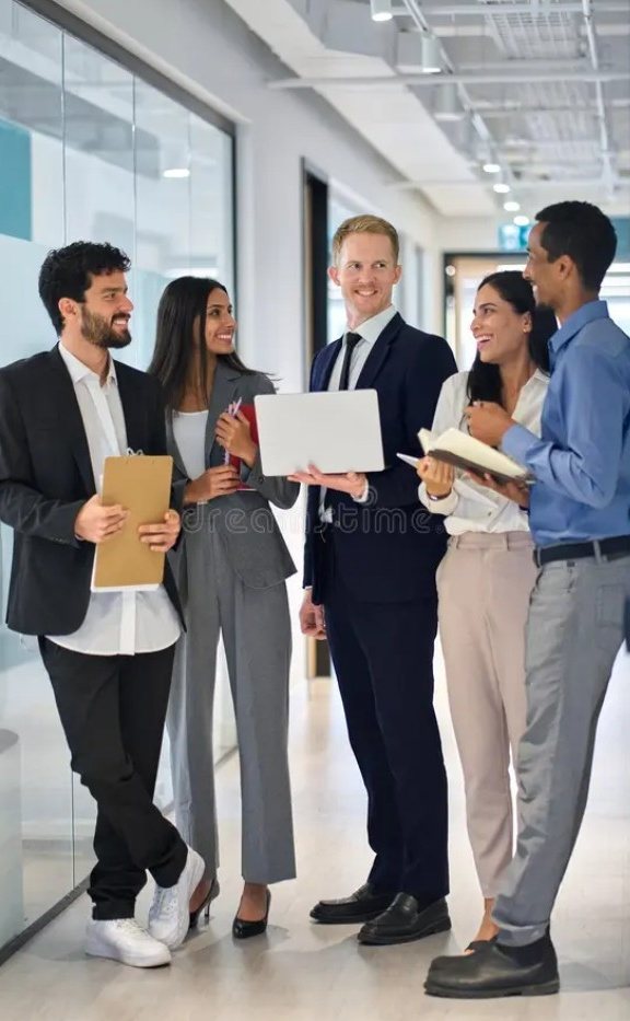 Colleagues talking in an office hallway